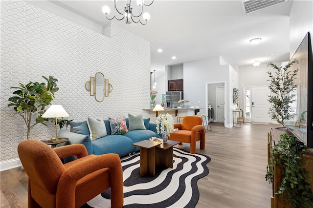 living room with light hardwood / wood-style floors and a chandelier