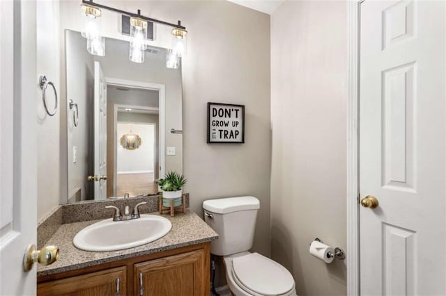 bathroom featuring vanity and toilet