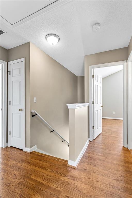 carpeted spare room with visible vents, vaulted ceiling, baseboards, and ceiling fan