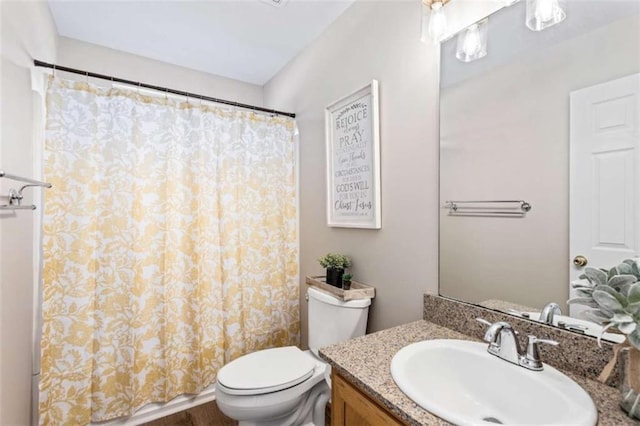 bathroom featuring toilet and vanity