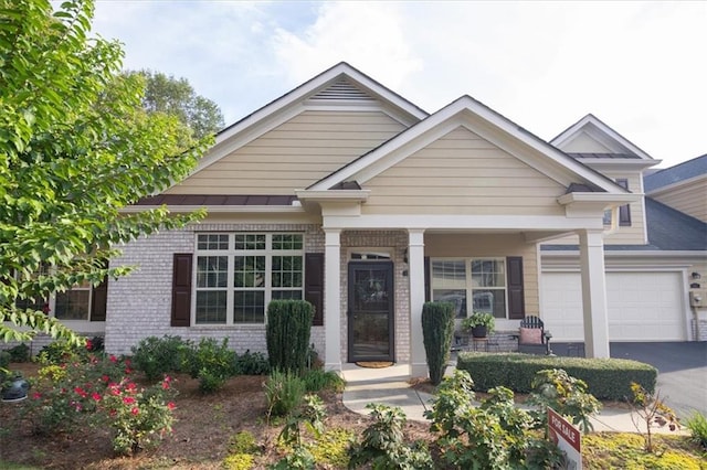 view of front facade featuring covered porch and a garage