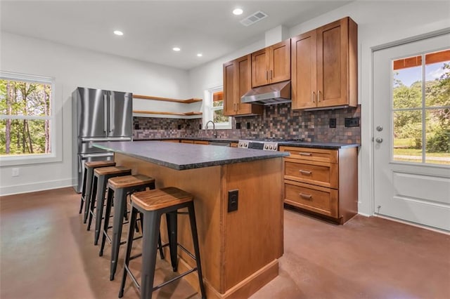 618 W Glade Creek Rd, Clarkesville, GA 30523 - kitchen featuring under cabinet range hood, freestanding refrigerator, open shelves, a kitchen island, and dark countertops