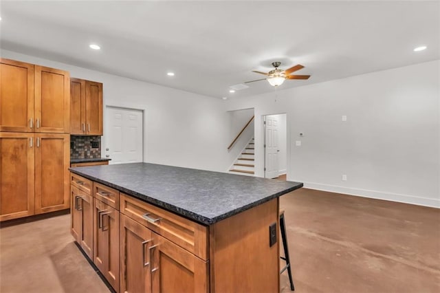 618 W Glade Creek Rd, Clarkesville, GA 30523 - kitchen with dark countertops, a ceiling fan, a kitchen bar, recessed lighting, and a kitchen island