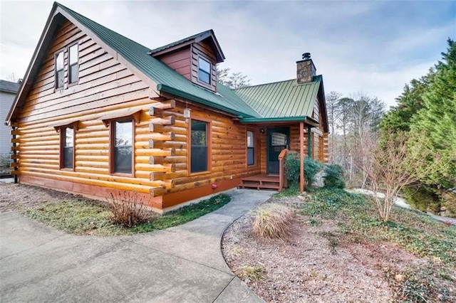 view of front of house with metal roof and log exterior