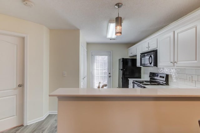 kitchen with black appliances, light wood-type flooring, decorative backsplash, a peninsula, and white cabinetry