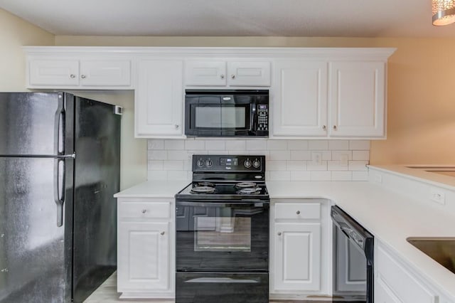 kitchen featuring black appliances and white cabinets