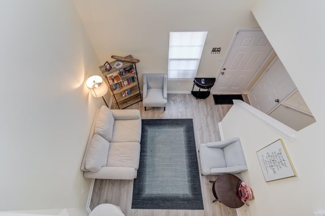 living area with wood finished floors and baseboards