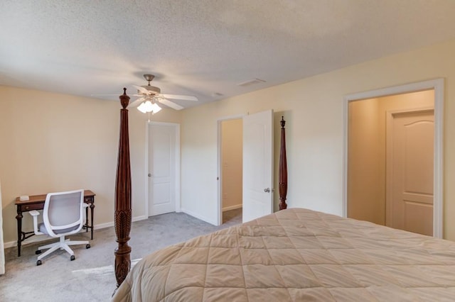 bedroom featuring ceiling fan, a textured ceiling, baseboards, and carpet floors
