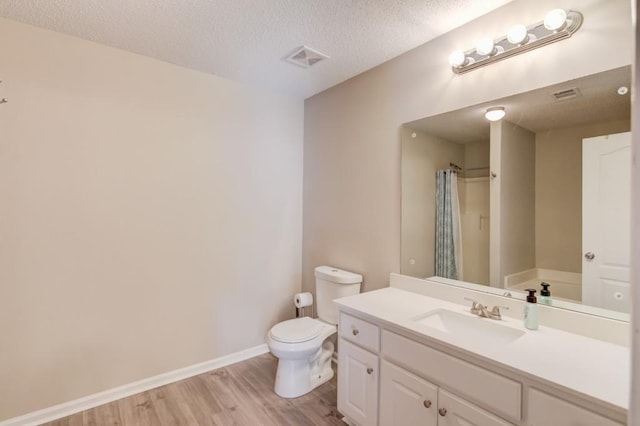 full bathroom featuring wood finished floors, baseboards, visible vents, a textured ceiling, and toilet