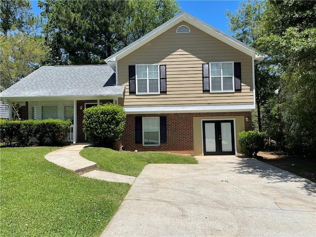 tri-level home with a front lawn and french doors