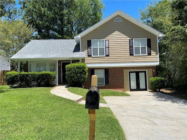 tri-level home with french doors and a front lawn