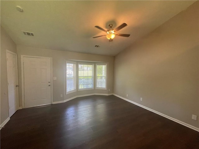 spare room featuring ceiling fan, lofted ceiling, and dark hardwood / wood-style floors