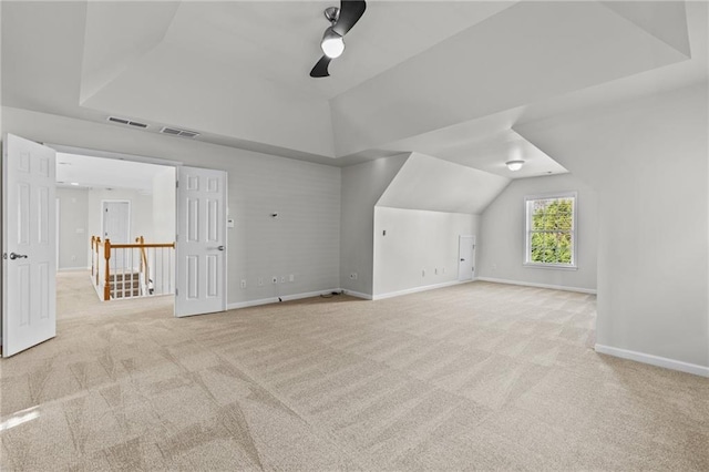 additional living space featuring visible vents, baseboards, carpet floors, lofted ceiling, and ceiling fan