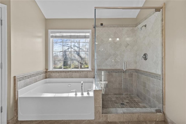 full bathroom with a garden tub and a shower stall