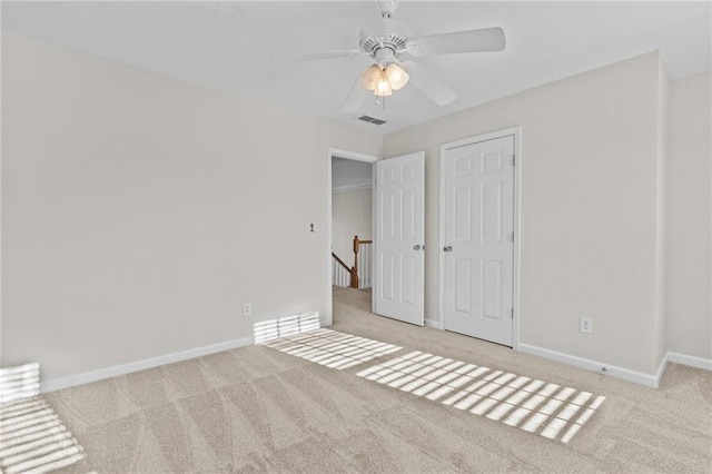 unfurnished bedroom featuring visible vents, a ceiling fan, baseboards, and carpet floors