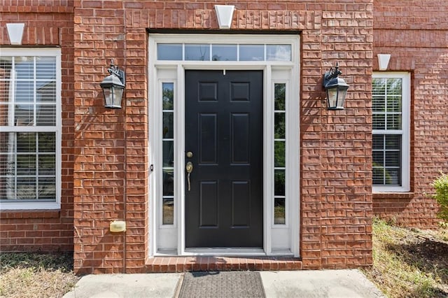 property entrance with brick siding