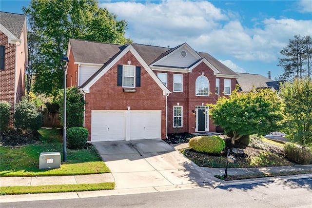 view of front of home with driveway, brick siding, and an attached garage