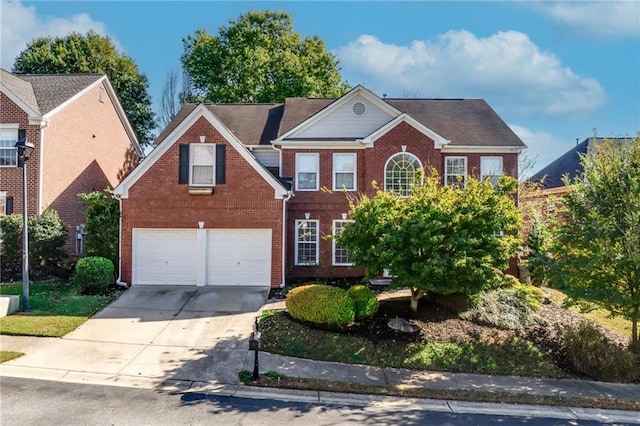 view of front of home with a garage, brick siding, and driveway