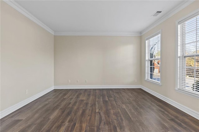 unfurnished room featuring visible vents, baseboards, dark wood finished floors, and ornamental molding