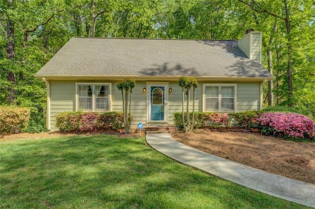 3957 Woodland Cir, Conyers, GA 30013 - view of front of property featuring a shingled roof, a chimney, and a front lawn