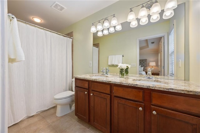 ensuite bathroom featuring tile patterned flooring, visible vents, a sink, and ensuite bathroom