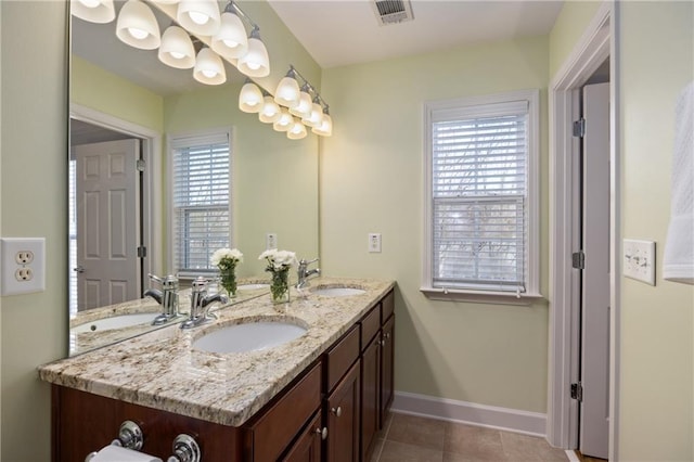 bathroom with visible vents, a sink, and double vanity