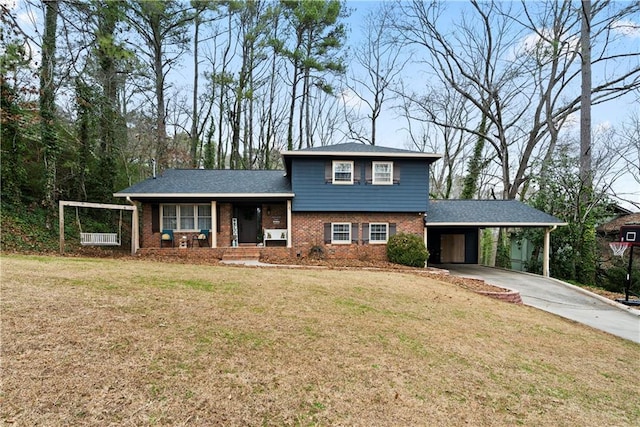 tri-level home with a carport, covered porch, and a front lawn