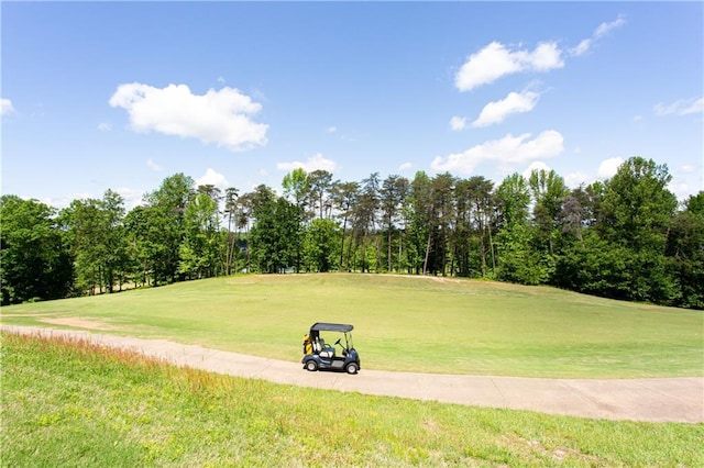 surrounding community with a lawn and view of golf course