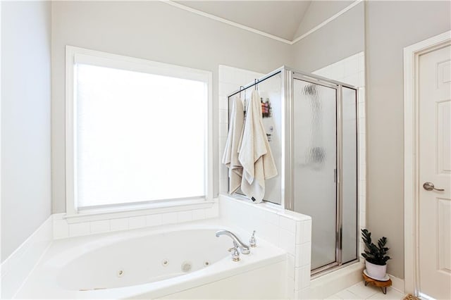 bathroom with a stall shower, a tub with jets, and lofted ceiling