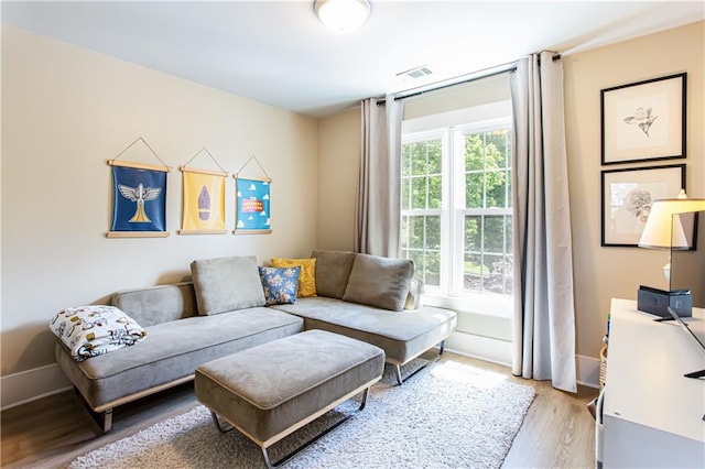 living room with light wood finished floors and baseboards