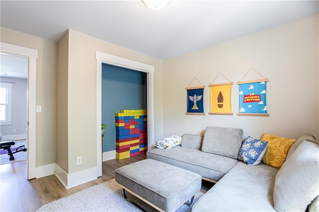 living area with wood finished floors and baseboards