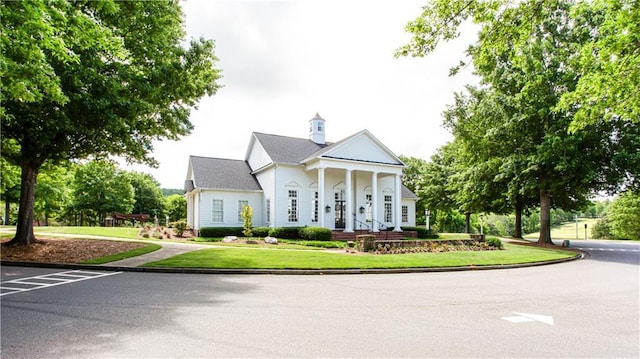 neoclassical home with a front yard