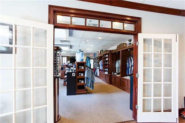hall featuring carpet, french doors, and a drop ceiling