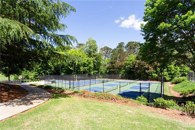 view of tennis court with view of scattered trees