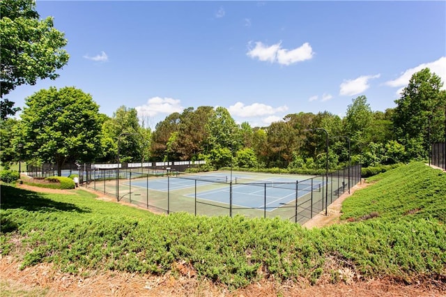 view of tennis court featuring fence