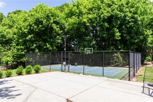 view of basketball court featuring community basketball court and fence