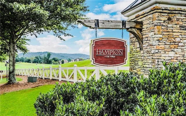 community / neighborhood sign featuring fence and a mountain view