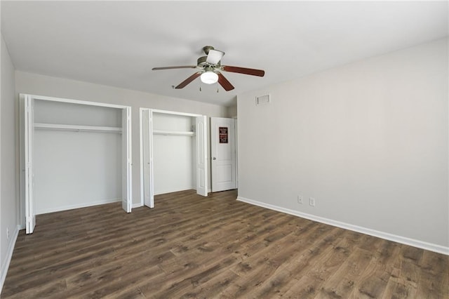 2825 NE Expy NE Unit F003, Atlanta, GA 30345 - unfurnished bedroom featuring two closets, dark wood-style flooring, and ceiling fan