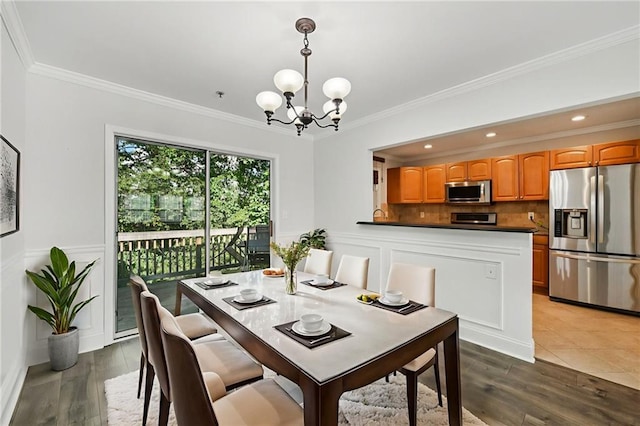 2825 NE Expy NE Unit F003, Atlanta, GA 30345 - dining room featuring a chandelier, ornamental molding, wood finished floors, a decorative wall, and a wainscoted wall
