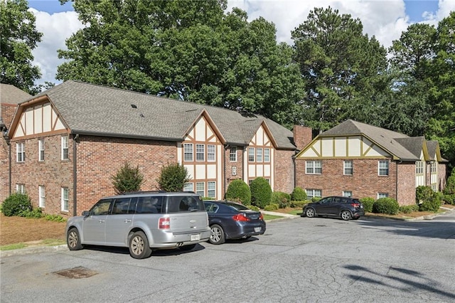 2825 NE Expy NE Unit F003, Atlanta, GA 30345 - view of front of home featuring uncovered parking and brick siding