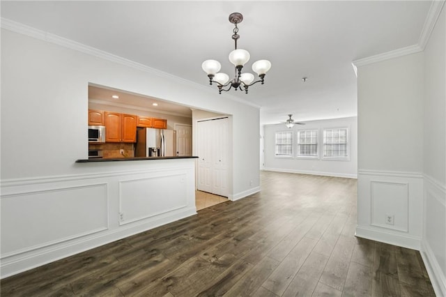 2825 NE Expy NE Unit F003, Atlanta, GA 30345 - kitchen with appliances with stainless steel finishes, dark countertops, a chandelier, crown molding, and open floor plan