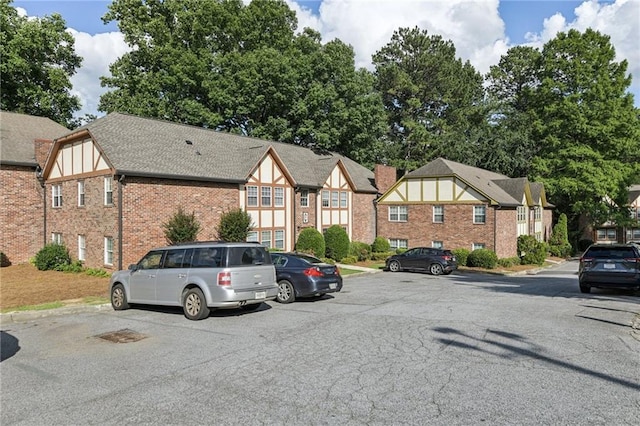 2825 NE Expy NE Unit F003, Atlanta, GA 30345 - view of front of house with brick siding, uncovered parking, and a residential view