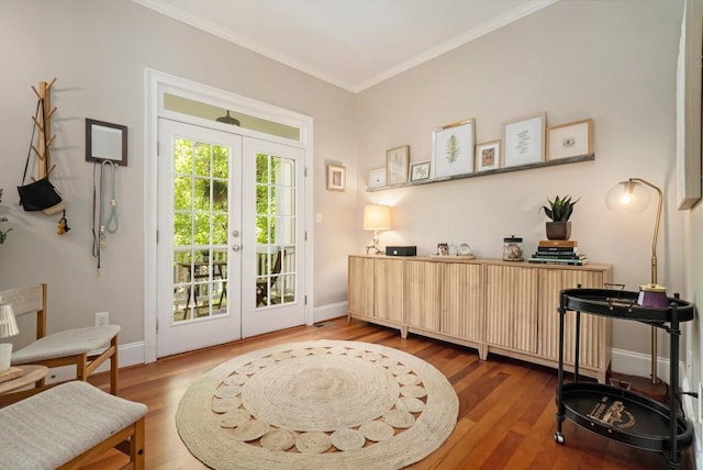 living area featuring french doors, wood finished floors, ornamental molding, and baseboards