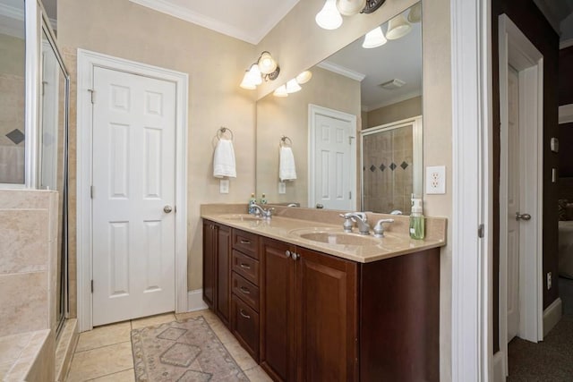 full bath featuring crown molding, a shower stall, double vanity, and tile patterned floors