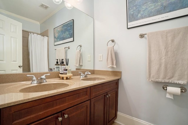 bathroom with crown molding and double vanity