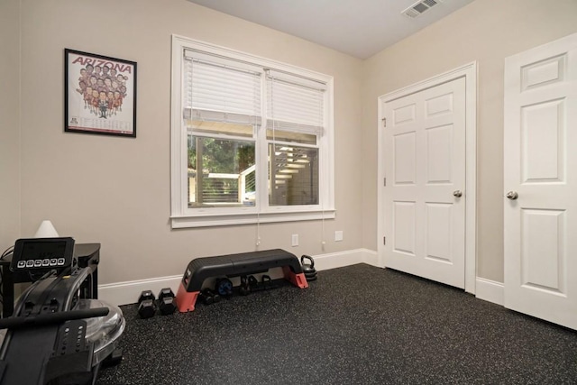 miscellaneous room featuring baseboards and dark rubber floors