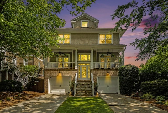 view of front facade with stairs, concrete driveway, a garage, and brick siding