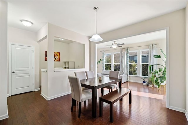 dining room with hardwood / wood-style flooring, baseboards, and a ceiling fan