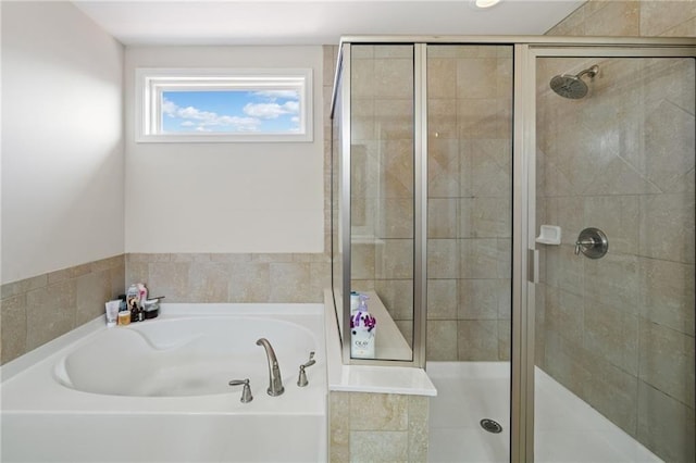 full bath featuring a bath and a stall shower