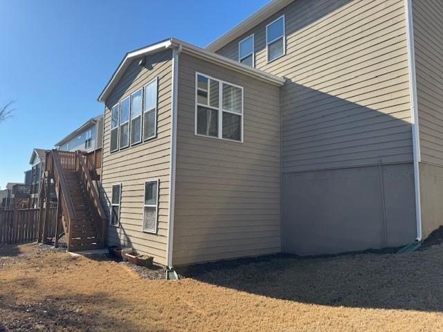 view of property exterior featuring stairs